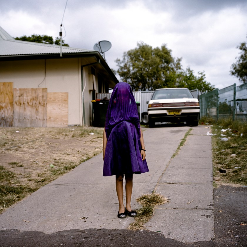 Laurinda waits in her purple dress for the bus that will take her to Sunday School. Moree, New South Wales.