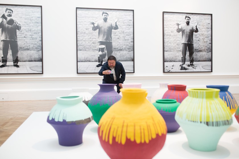 Ai Weiwei taking a photograph of his installation Coloured Vases, Royal Academy of Arts, 2015. Ph. Dave Parry, Courtesy of Royal Academy of Arts, London. 
